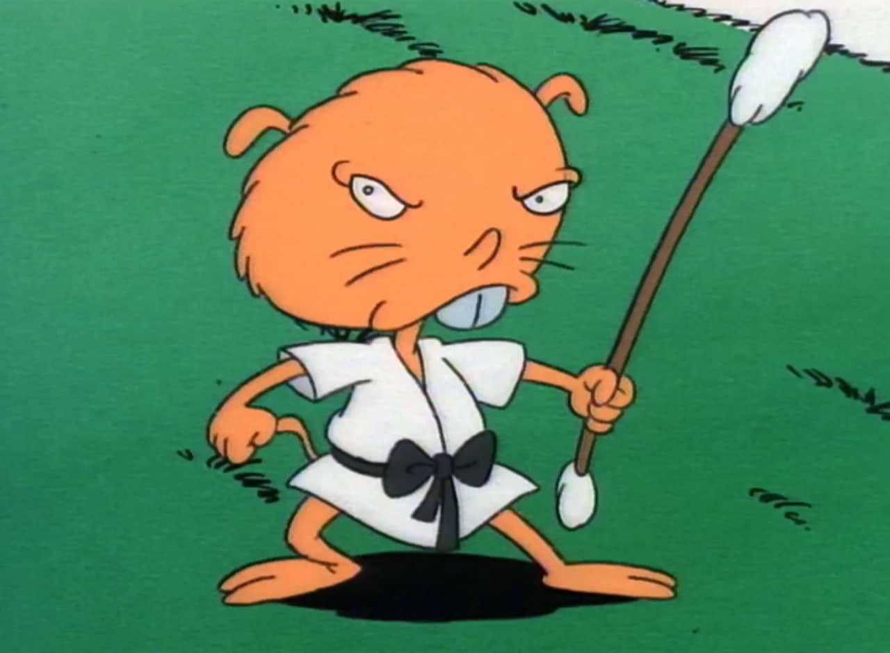 Lang-Chao, a gerbil in kung fu attire, wielding a Q-tip