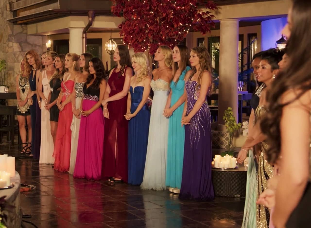 a row of women in evening dresses