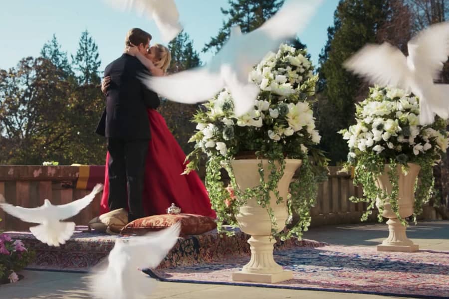 Adam Cromwell kissing Anna Martin with doves flying