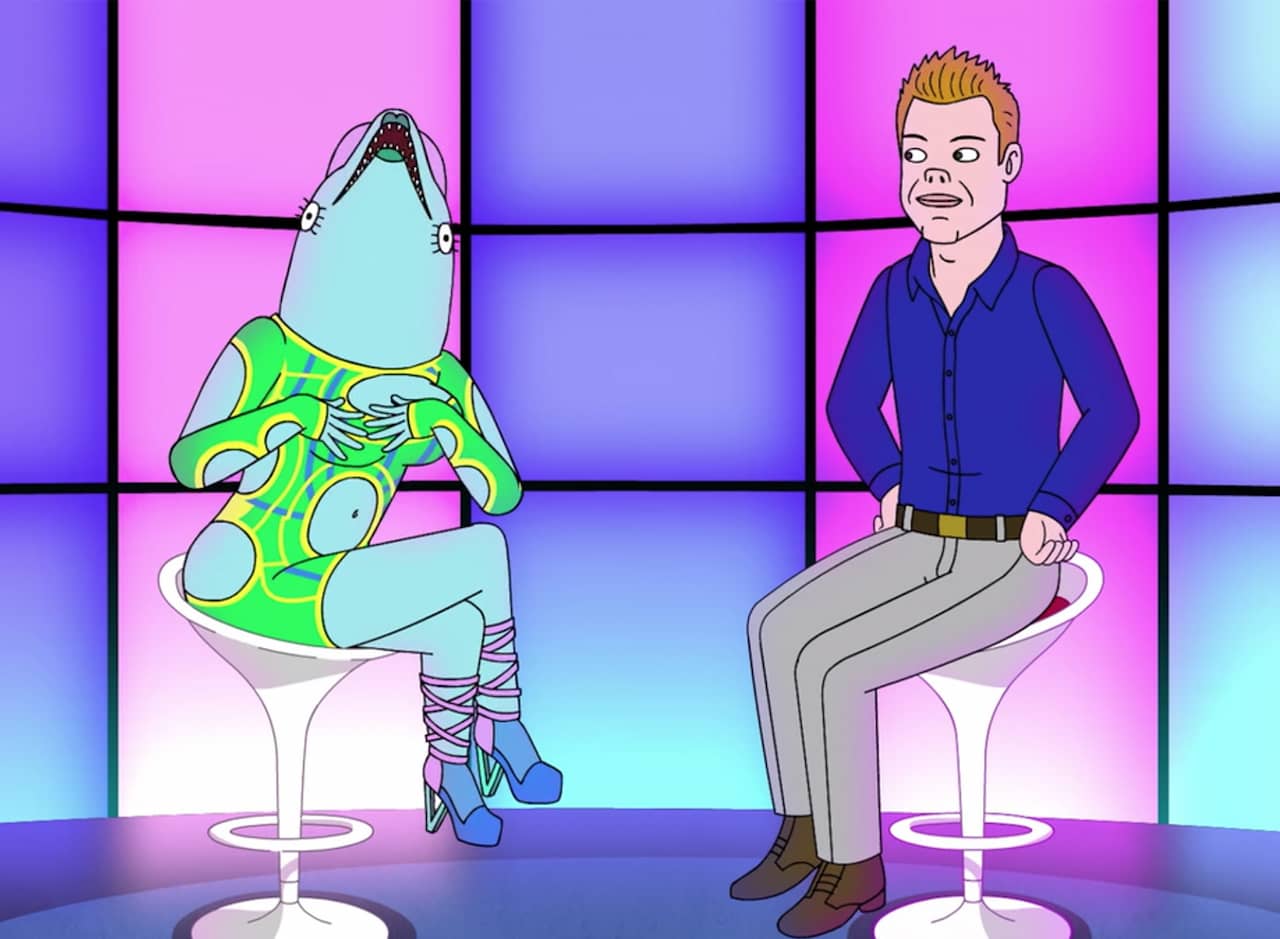 A Ryan Seacrest Type interviews a dolphin in the studio