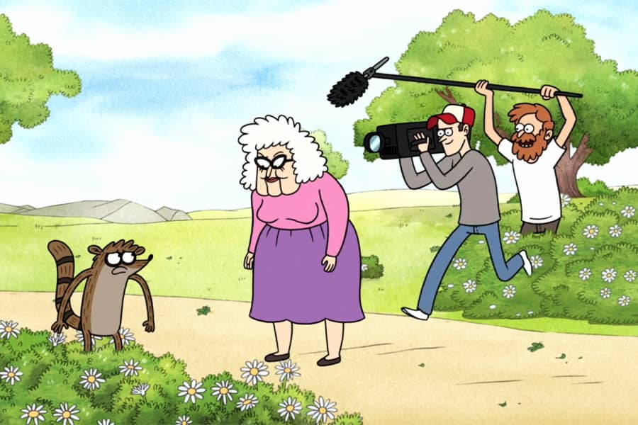 contestant Rigby is being questioned by a little old woman as a film crew emerges from the bushes