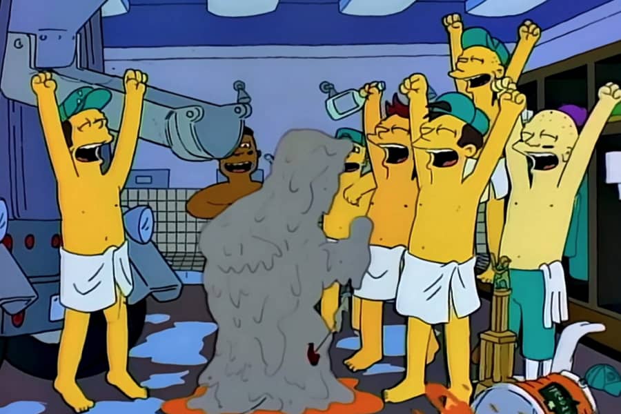 Brockman covered in cement as a baseball team celebrates in their locker room