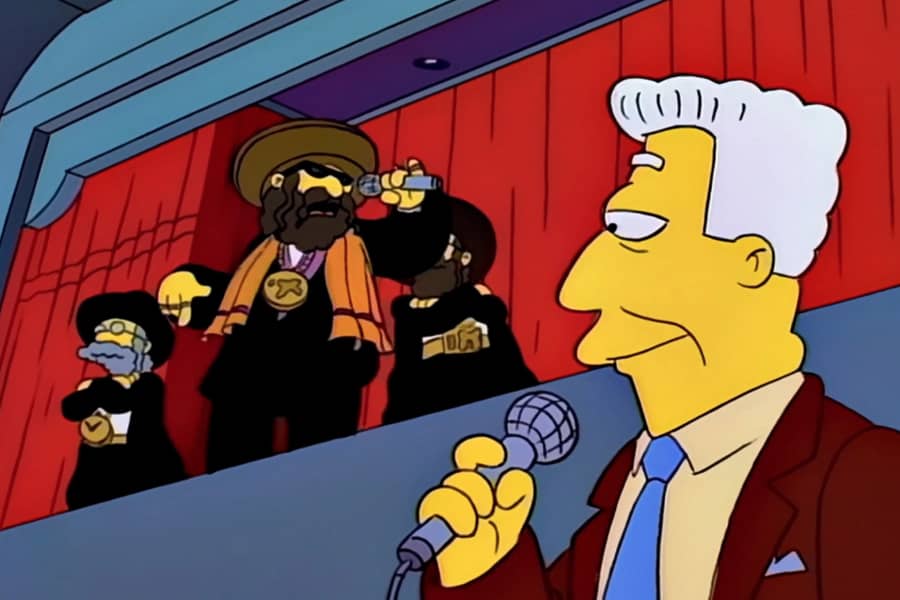 Brockman looking up at a stage where Orthodox Jewish men are rapping