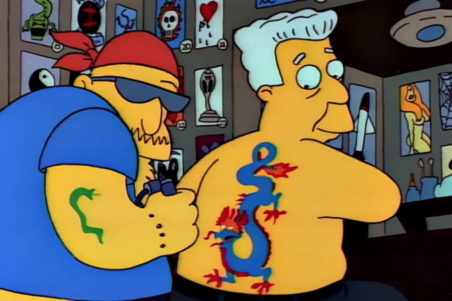 Brockman getting a giant dragon tattoo on his back