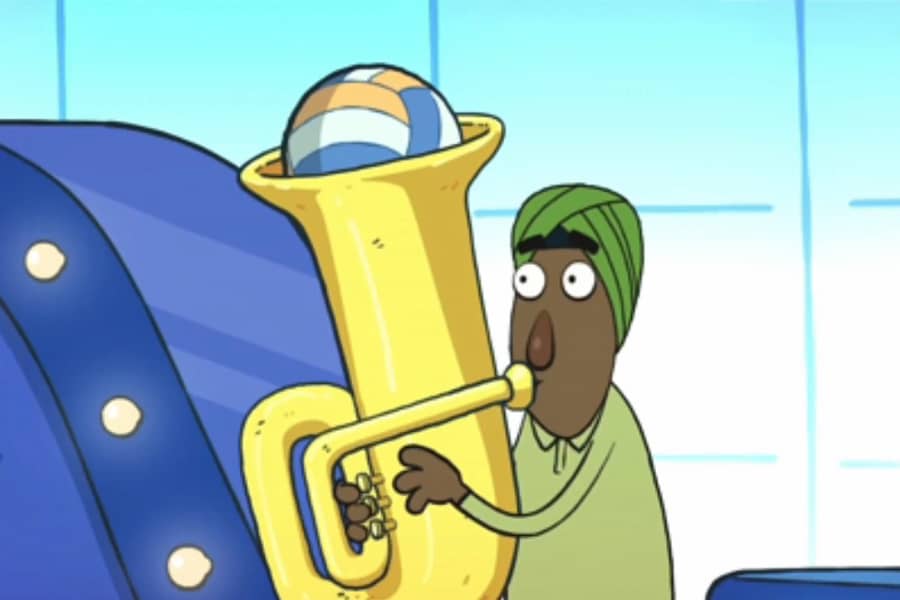 man blowing into a tuba with a volleyball inside the horn