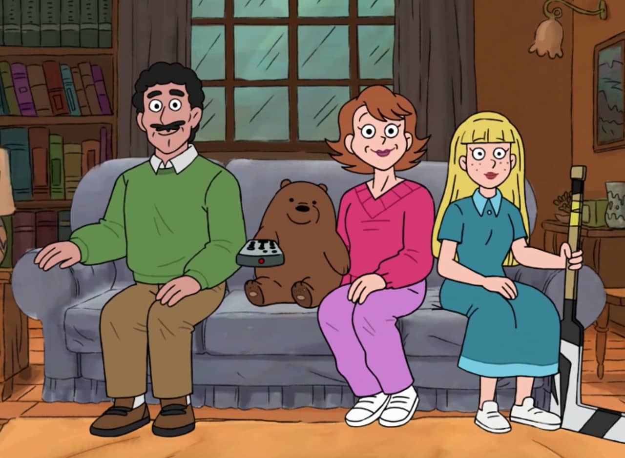a family sitting on the couch watching tv, one member is a little bear