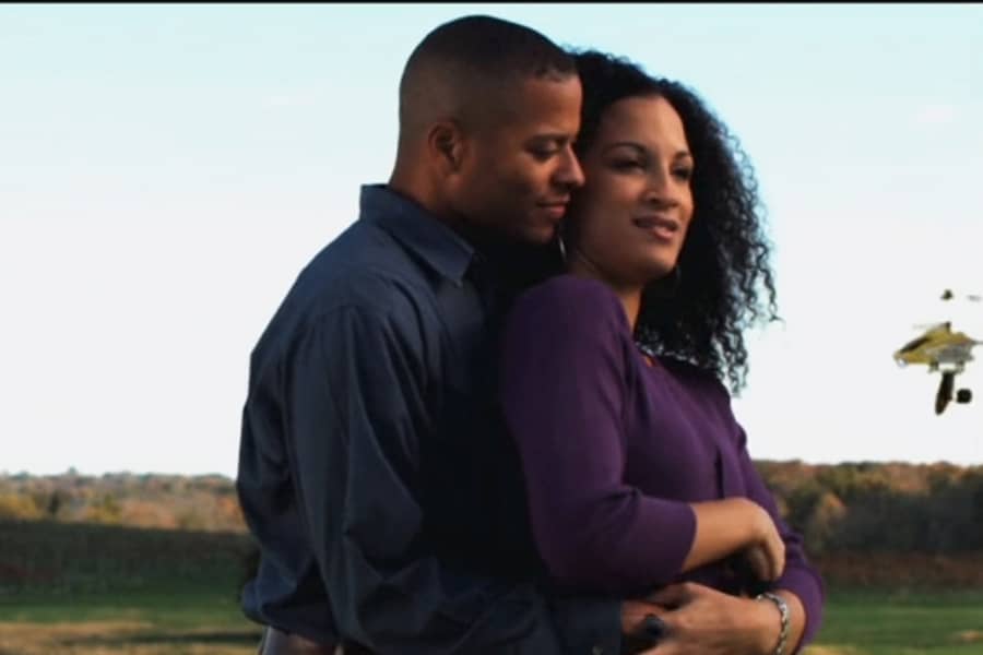 Black couple embracing and Fartcopteris flying nearby