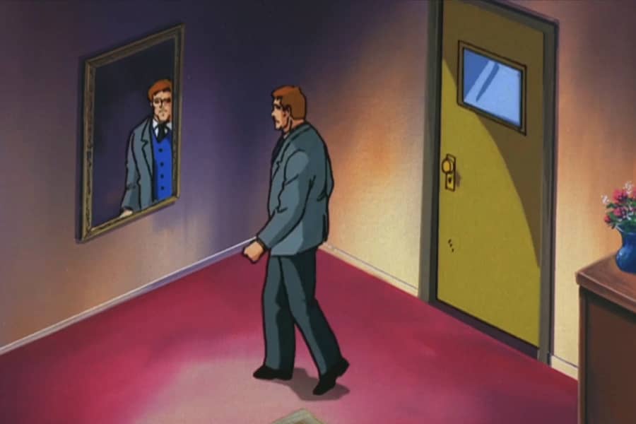 man walking to look into a mirror on the wall