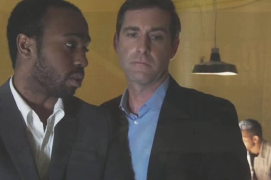 two detectives talking privately