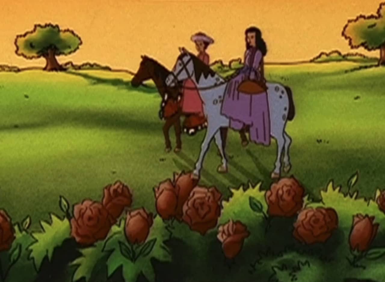 two women riding on horses past some rose bushes