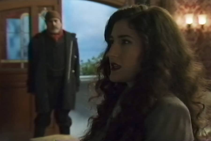the young woman, with another man in the doorway behind her