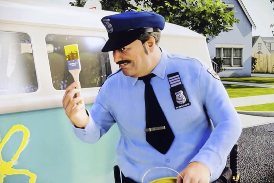 the cop has a paintbrush in his hand