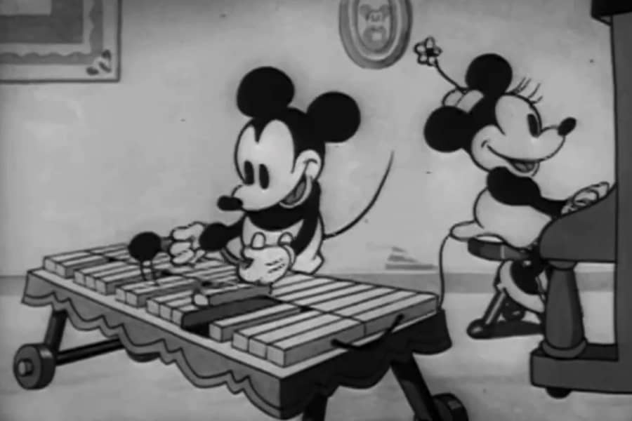 Mickey playing a xylophone and Minnie playing the piano
