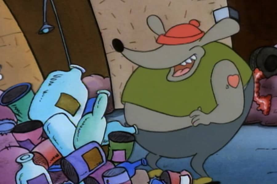 rat worker next to a giant pile of trash