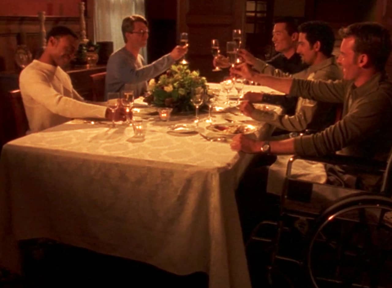 a table of men toast wine glasses