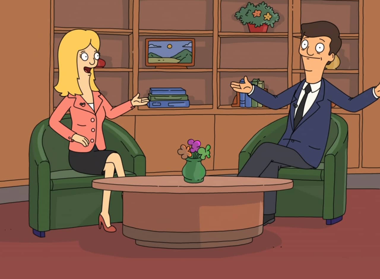 Chuck and Pam on their living room set