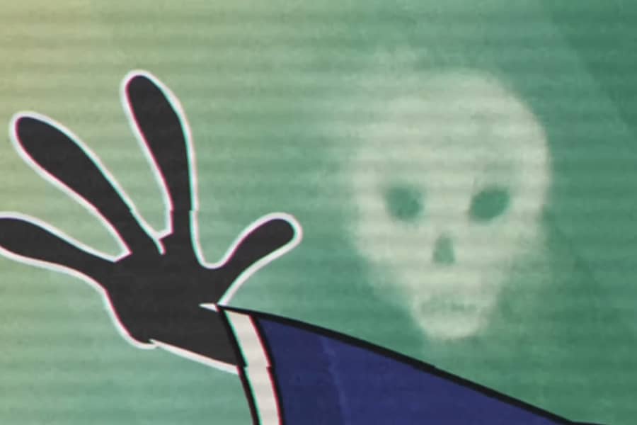 Rich Ghoulish’s hand next to a white skull on the window’s surface