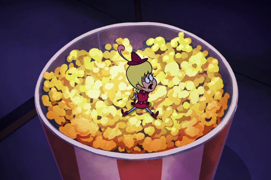 Flirtacia sitting in a bit tub of popcorn