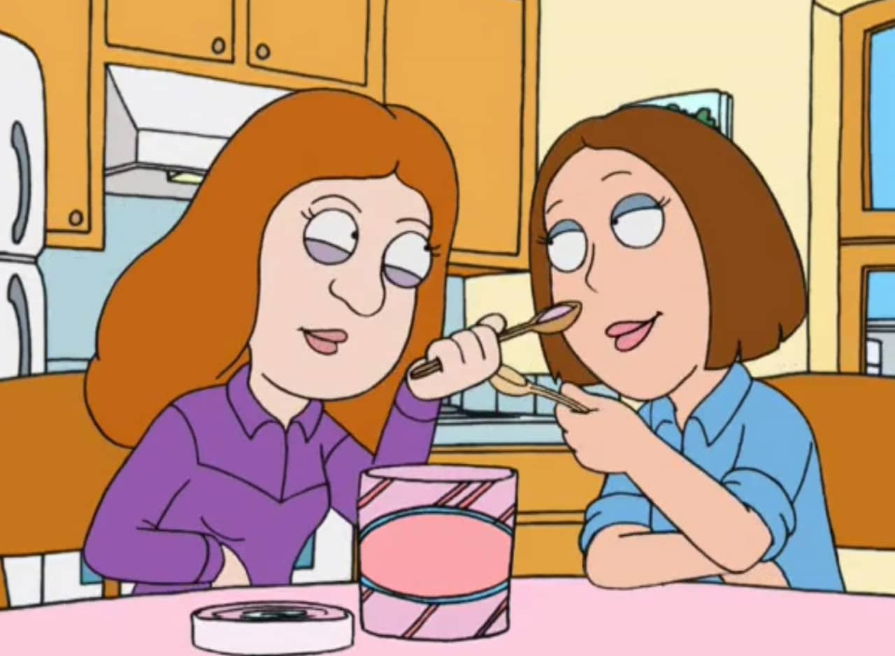 two ladies sharing a tub of ice cream