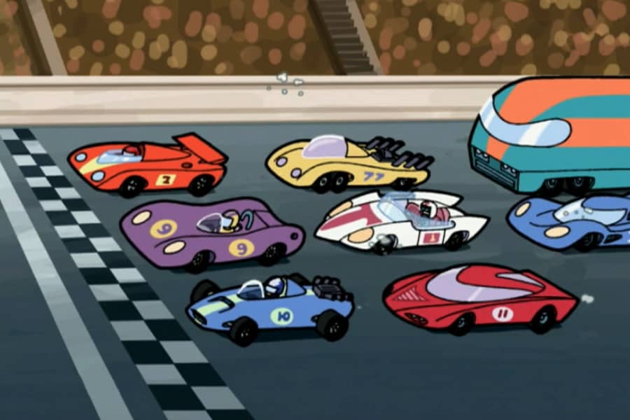 a bunch of colorful racing cars at the starting line
