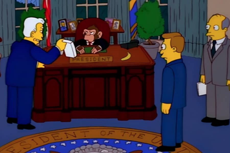 men showing a report to the chimp President