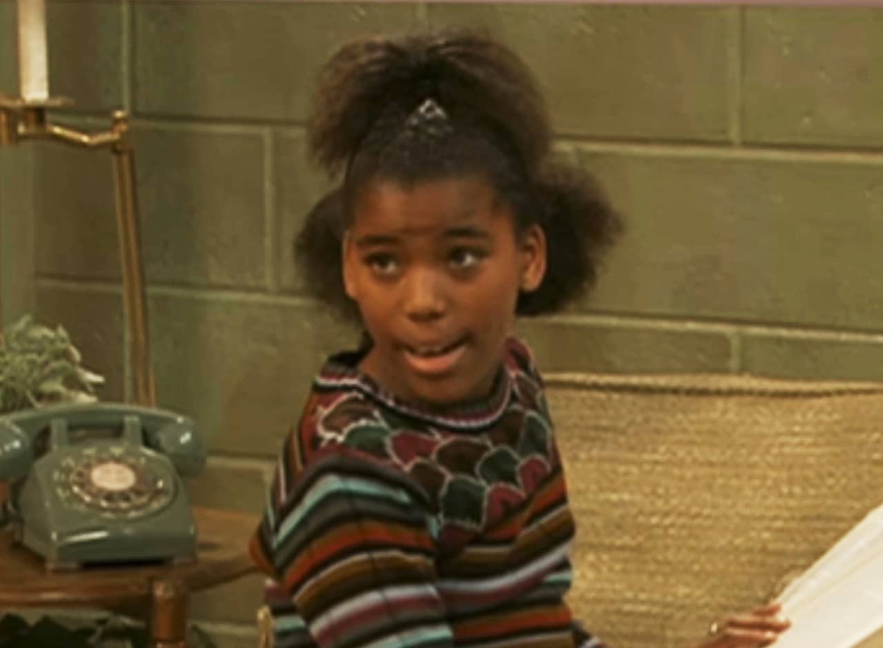 Helen Dubois, a young Black girl reading a book