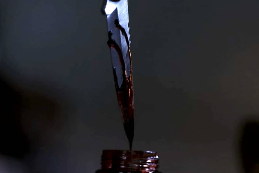 a knife covered in dripping blood