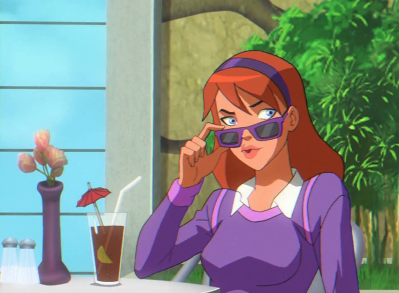 Megan, a red-haired teen, lowers her purple sunglasses