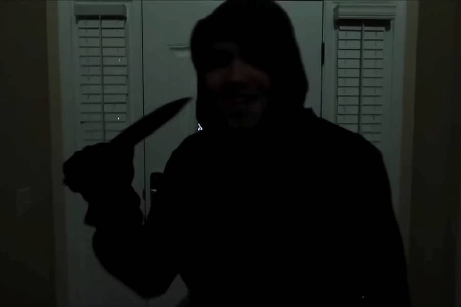 hooded man holding a knife