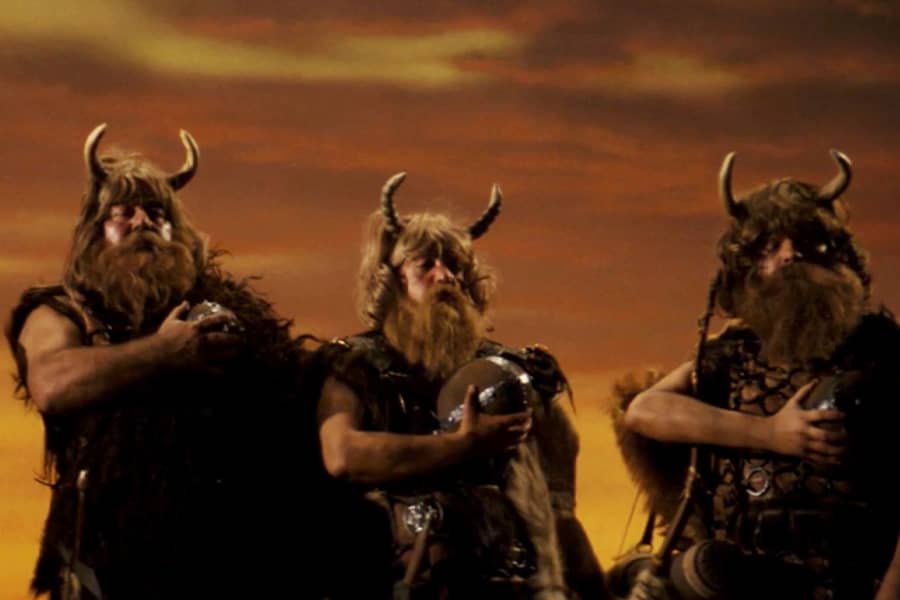 vikings with helmets removed, but the horns remain on their heads