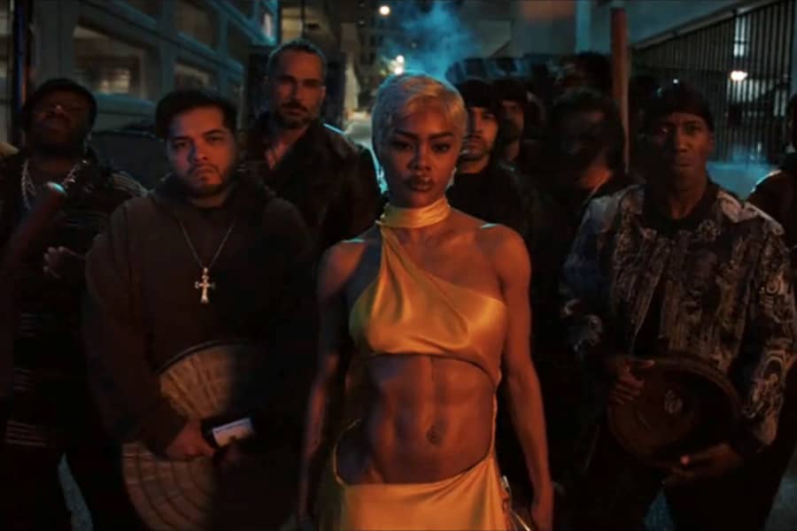 Teyana Taylor with a gang of tough dudes behind her in an alley