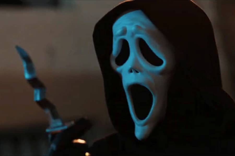 Ghostface holding a knife that’s been crunched into a zigzag shape