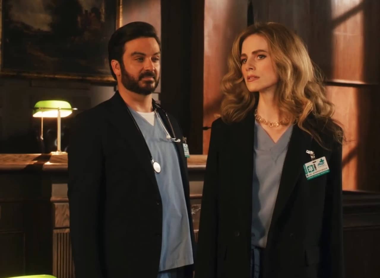 Dr. Jennifer Braun and Dr. Rodondo wearing scrubs in a courtroom