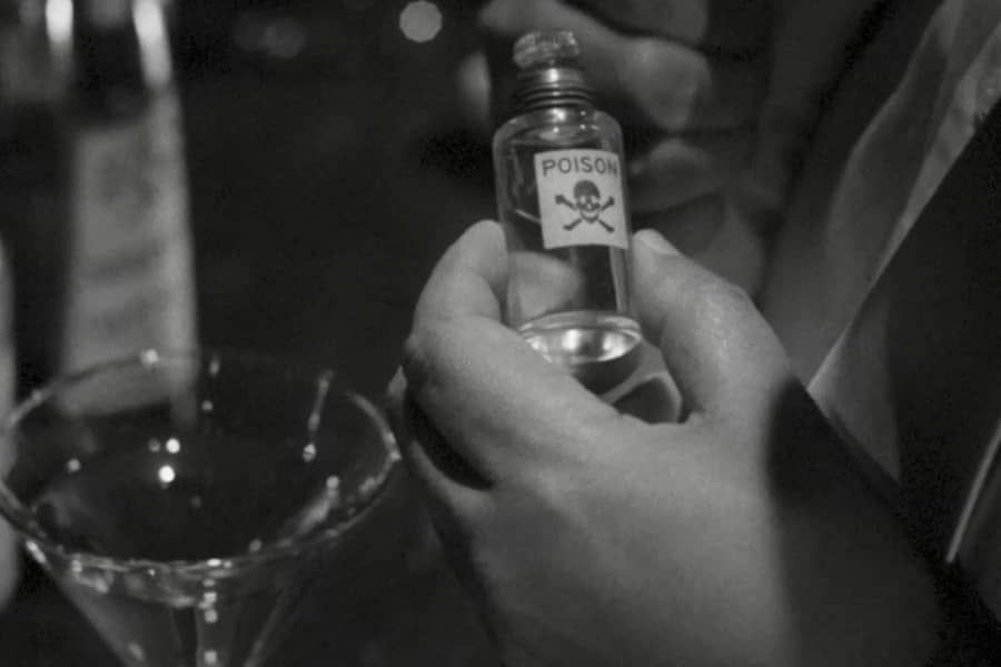 hands with a small bottle of poison