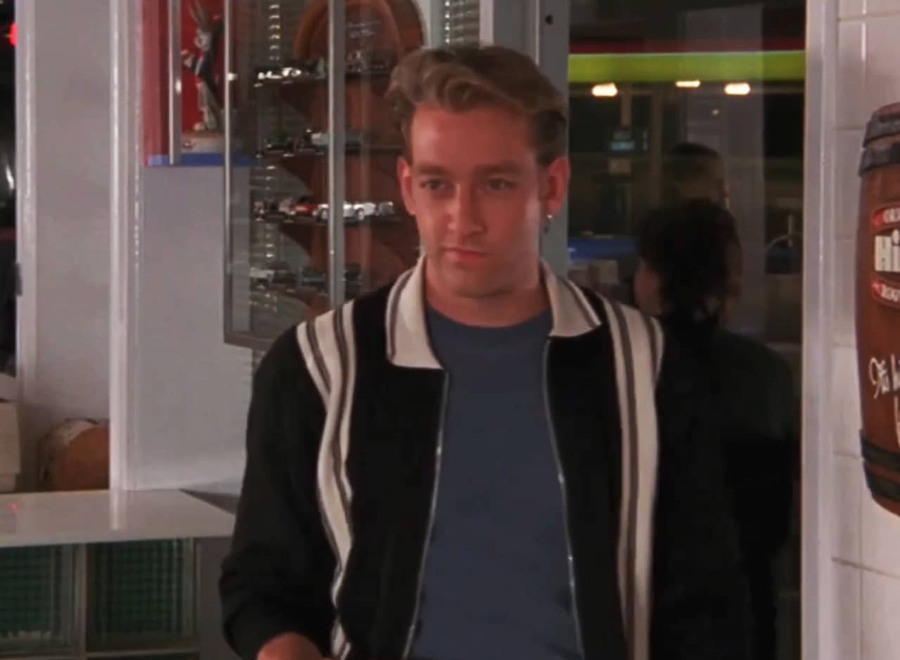 young college guy enters a pizza parlor