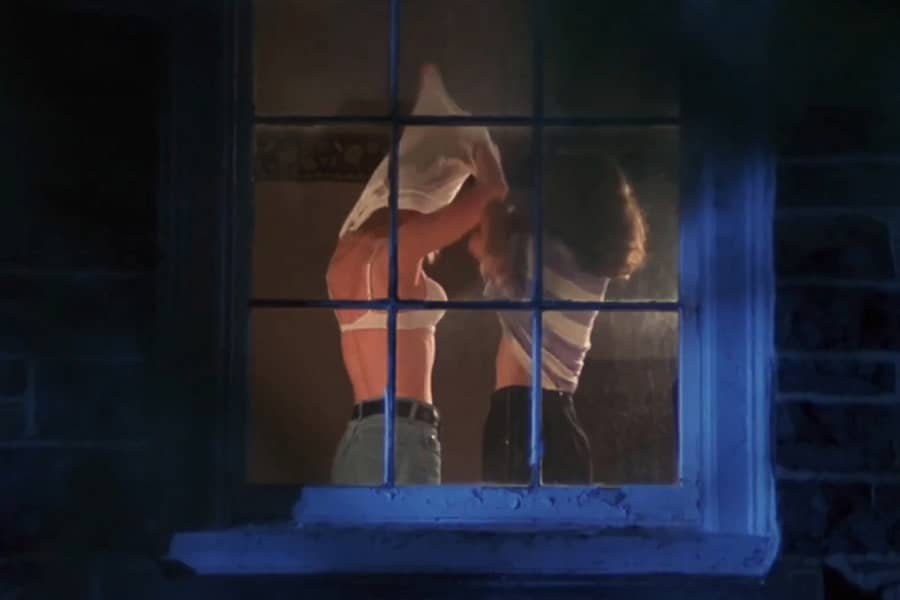 looking into a window and two girls are undressing