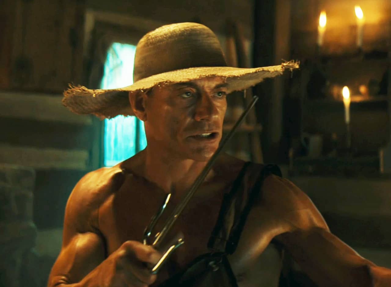 Jean-Claude Van Damme as a shirtless Huck Finn wielding twin sai