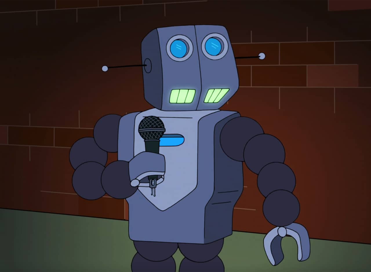 Humorbot on stage with a microphone