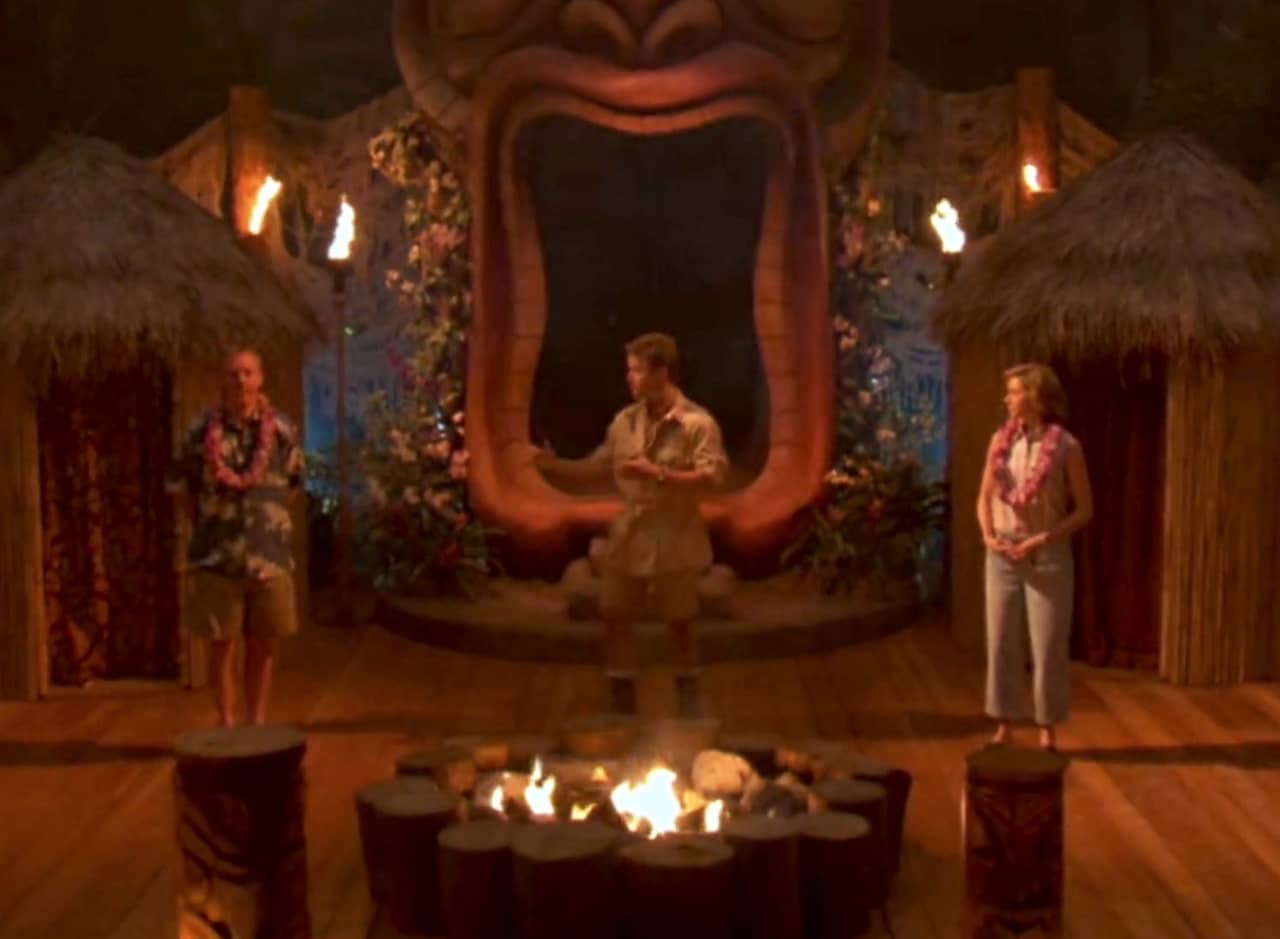 Billy Bush on a tropical island tiki set with sort of basic looking white couple