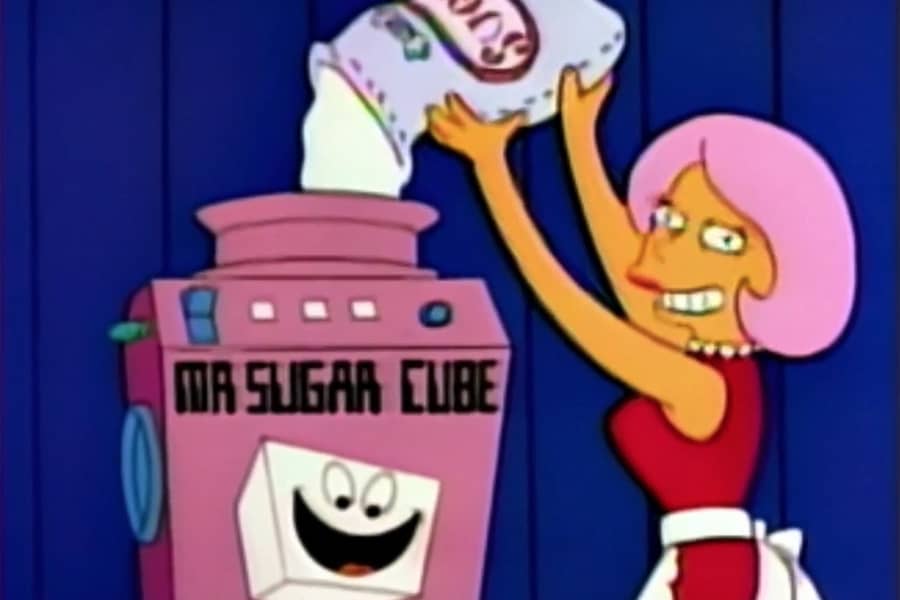 woman pouring a bag of sugar into a Mr. Sugarcube machine