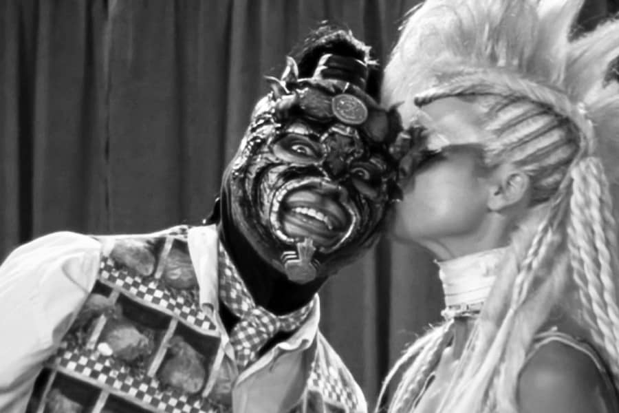 blonde woman kissing Lothor on the cheek