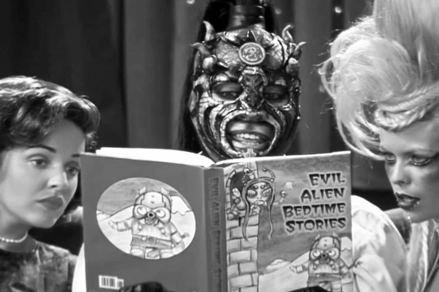 Lothor reading evil alien bedtime stories to the two women