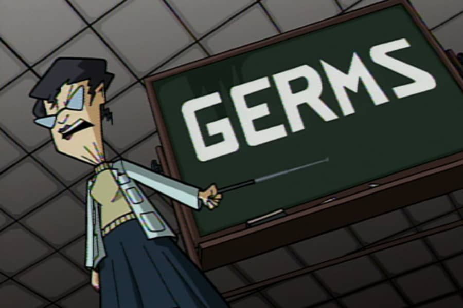 scientist pointing at a blackboard with the word “Germs”