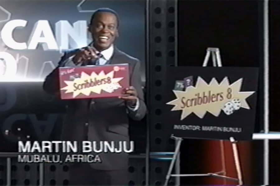 Martin Bunju presenting his board game invention, Scribblers 8