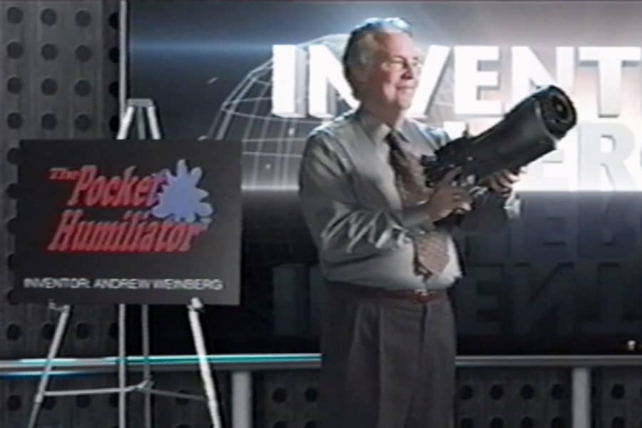 Andrew Weinberg presenting his bazooka-like invention, The Pocket Humiliator