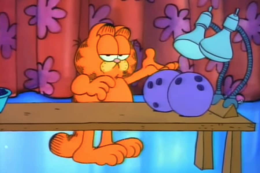 Garfield with two lamps pointed at two bowling balls