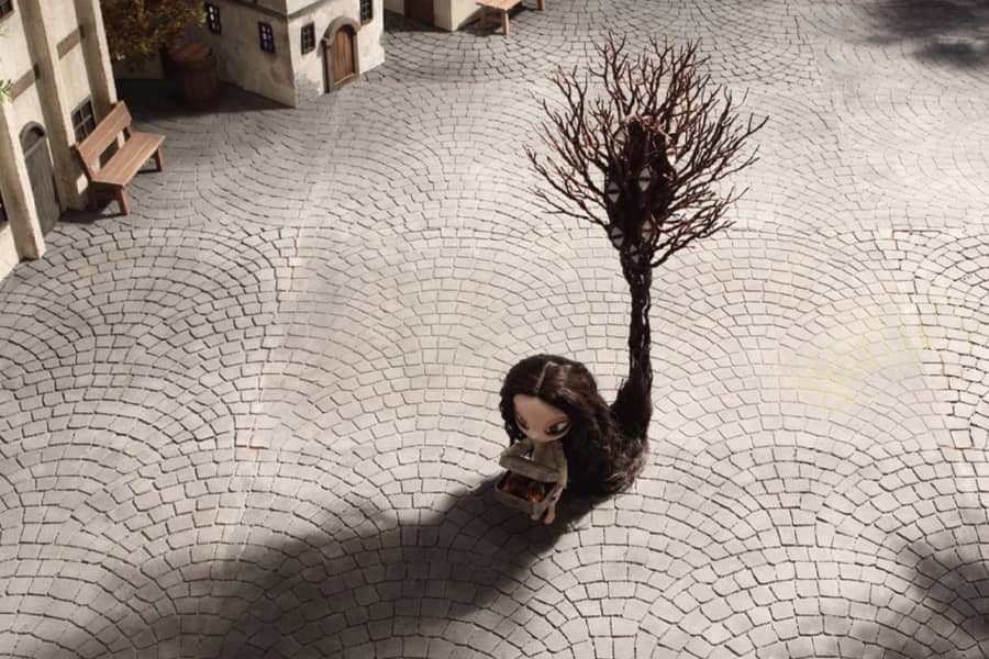 small girl whose long hair is a tree-like monster