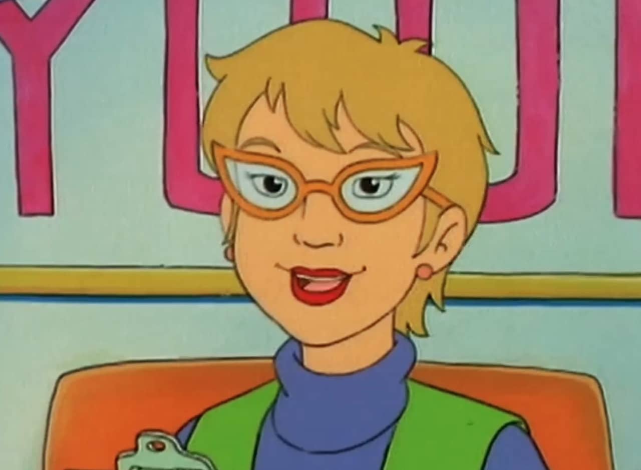 Gerri Poveri, a white woman with short hair and red glasses