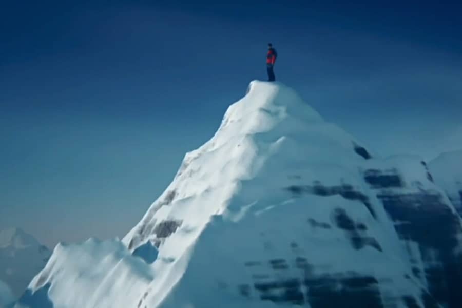 Jack Mimoun atop a snowy mountain