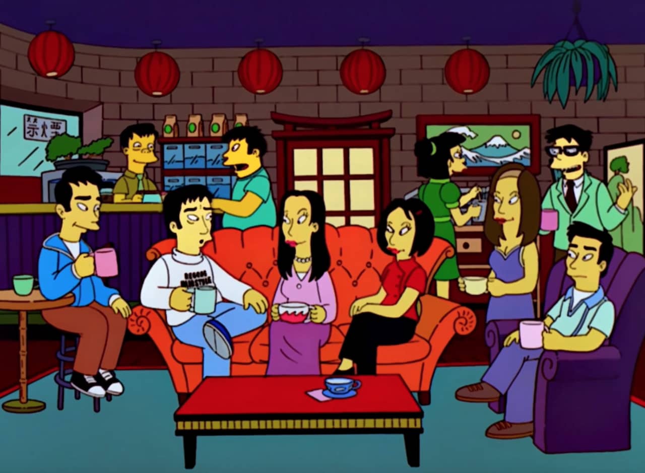 a group of 6 Japanese friends sitting in a coffee shop